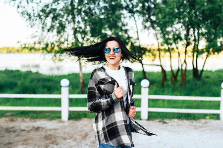Pretty brunette girl have fun outdoor in the parkの写真素材