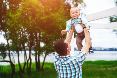Young father with his little son have fun outdoor in the parkの写真素材