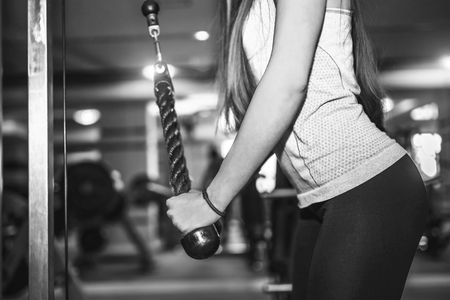 Pretty sporty girl training in the gym, black and whiteの写真素材