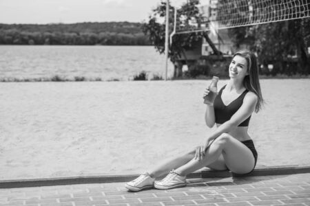 Pretty young sporty girl relaxing after outdoor training, black and whiteの写真素材