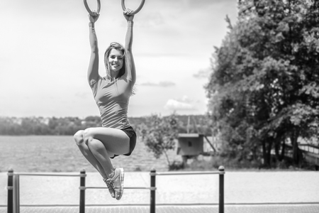 Pretty young brunette sporty girl workout outdoor, black and whiteの写真素材