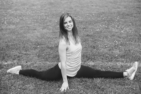 Pretty young brunette sporty girl workout outdoor, black and whiteの写真素材