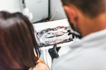 Dentist showing for the patient result of treatmentの写真素材