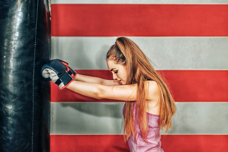 Pretty sporty girl boxing in the gymの写真素材