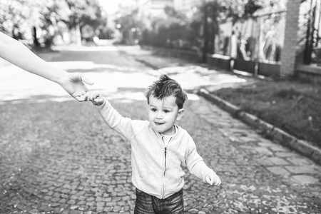 Young mother with her little son outdoor in the park, black and whiteの写真素材