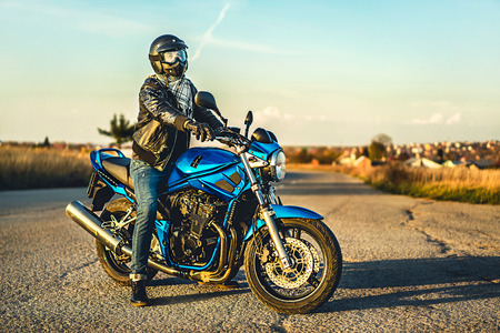 Biker on sport motorcycle outdoor on the roadの写真素材