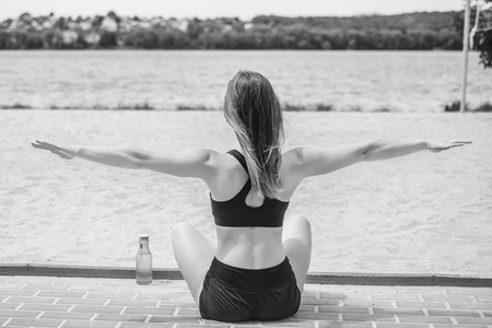 Pretty young brunette sporty girl workout outdoor, black and whiteの写真素材
