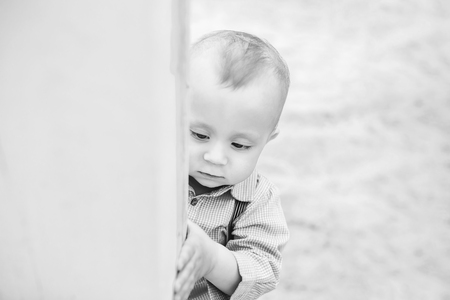 Cute little boy playing outdoor in the park, black and whiteの写真素材