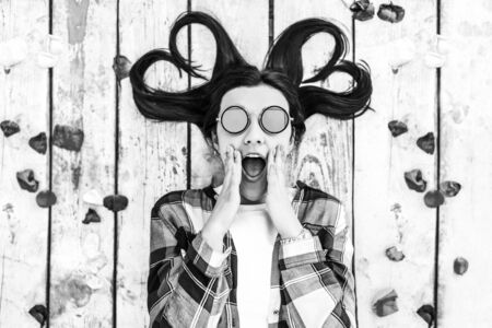 Pretty brunette girl relaxing on wooden backgroundの写真素材
