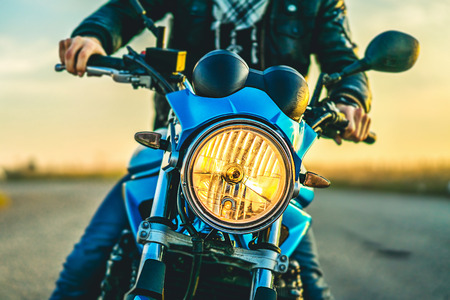 Biker on sport motorcycle outdoor on the roadの写真素材