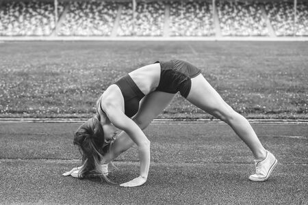 Pretty young brunette sporty girl workout outdoor, black and whiteの写真素材