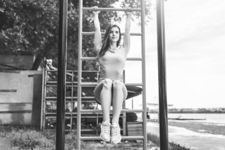 Pretty sporty girl workout outdoor on the sports ground, black and whiteの写真素材