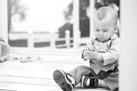 Cute little boy playing outdoor in the park, black and whiteの写真素材