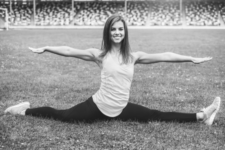 Pretty young brunette sporty girl workout outdoor, black and whiteの写真素材