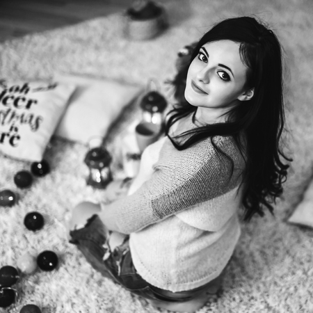 Happy pregnant woman at home with christmas decorationsの写真素材