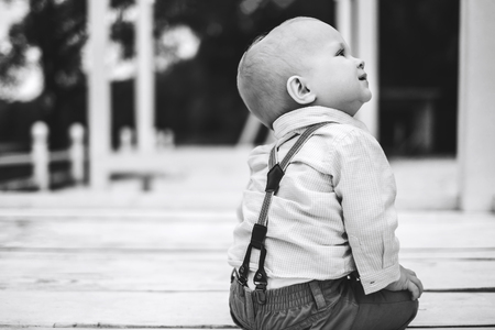 Cute little boy playing outdoor in the park, black and whiteの写真素材