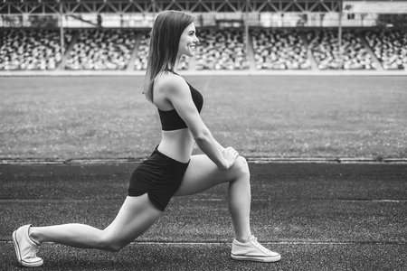 Pretty young brunette sporty girl workout outdoor, black and whiteの写真素材