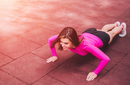 Pretty young brunette sporty girl workout outdoor