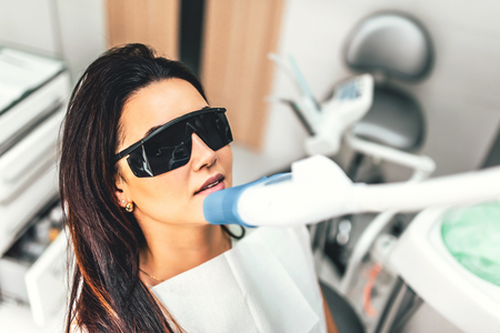 Teeth whitening in dental clinic for female patientの写真素材