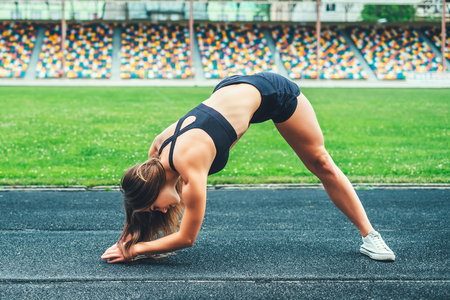 Pretty young brunette sporty girl workout outdoorの写真素材
