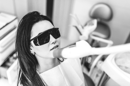 Teeth whitening in dental clinic for female patientの写真素材