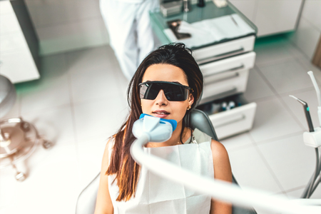 Teeth whitening in dental clinic for female patientの写真素材