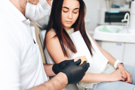 Dentist showing for the patient result of treatmentの写真素材