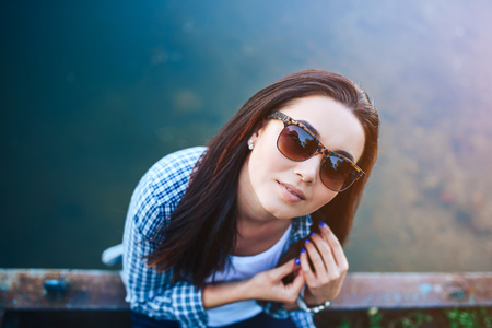 Pretty brunette women relaxing near lake outdoorの写真素材