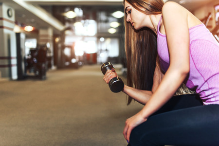 Pretty sporty girl training in the gymの写真素材
