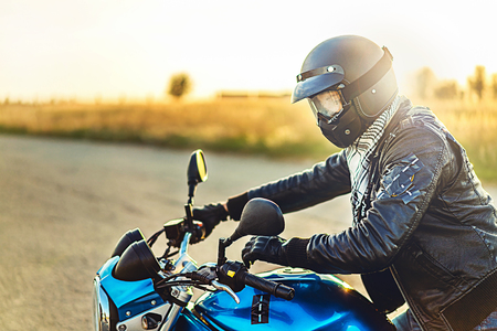 Biker on sport motorcycle outdoor on the roadの写真素材
