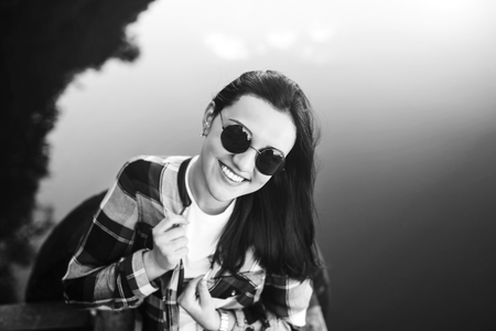 Pretty brunette women relaxing near lake outdoorの写真素材