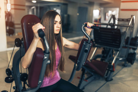 Pretty sporty girl training in the gym