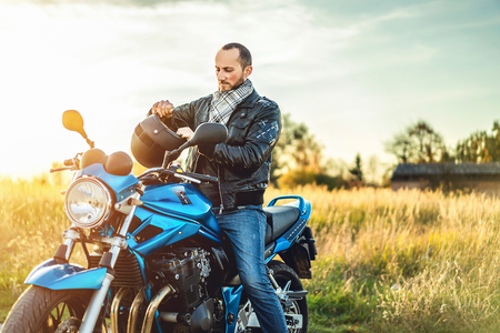 Biker on sport motorcycle outdoor on the roadの写真素材