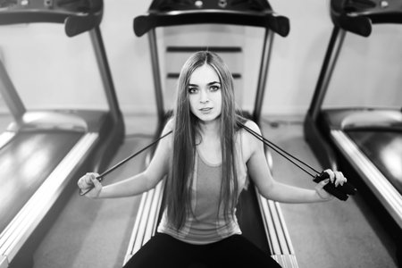 Pretty sporty girl training in the gym