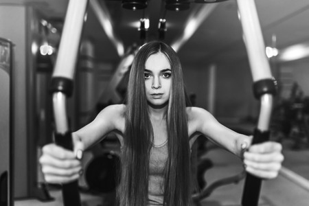 Pretty sporty girl training in the gymの写真素材