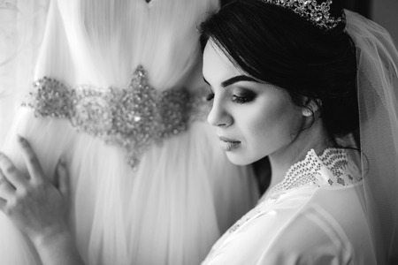 Beautiful bride dressing up before wedding ceremonyの写真素材