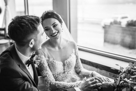 Pretty wedding cuople relaxing in resturantの写真素材