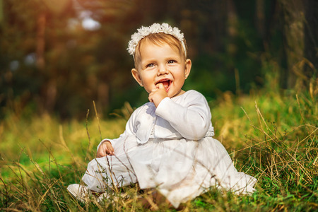 Cute little baby girl playing outdoorの写真素材