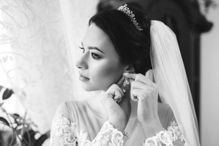 Pretty bride dressing up before wedding の写真素材
