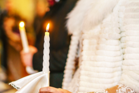 Wedding ceremony in church with candle in handsの写真素材