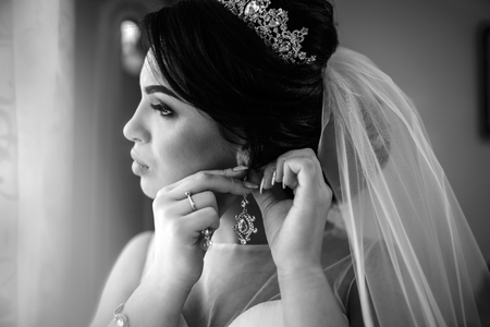 Beautiful bride dressing up before wedding ceremonyの写真素材