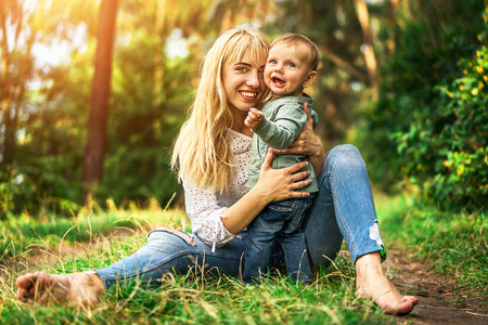Happy mother with her little daughter playing outdoorの写真素材