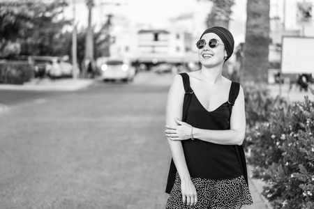 Pretty brunette tourist girl walking on the streetの写真素材