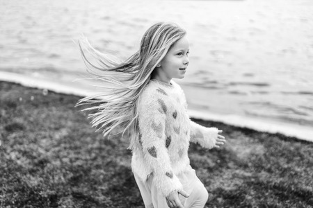 Little happy pretty girl outdoor in the parkの写真素材