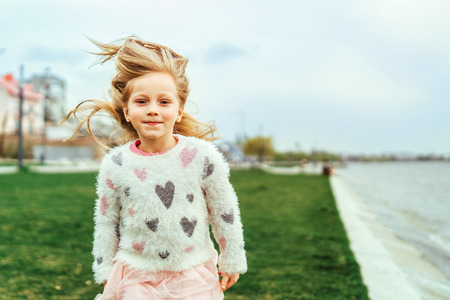 Little happy pretty girl outdoor in the parkの写真素材