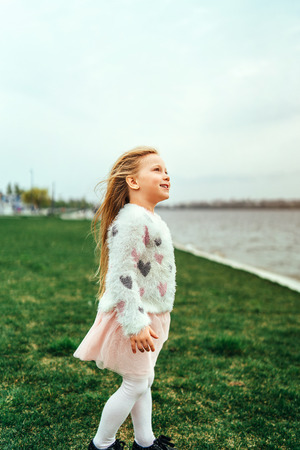 Little happy pretty girl outdoor in the parkの写真素材