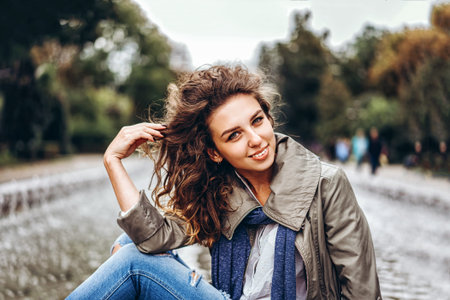 Pretty girl with curly hair relaxing outdoor