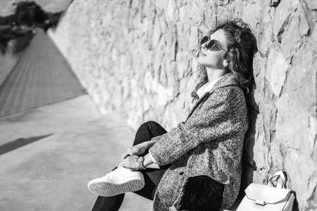 Pretty girl with curly hair relaxing outdoorの写真素材