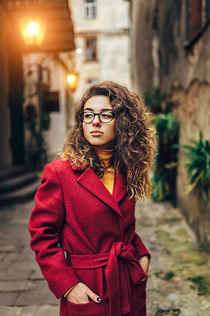 Pretty girl with curly hair walking outdoorの写真素材