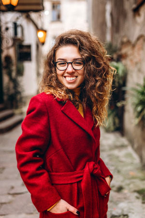 Pretty girl with curly hair walking outdoorの写真素材